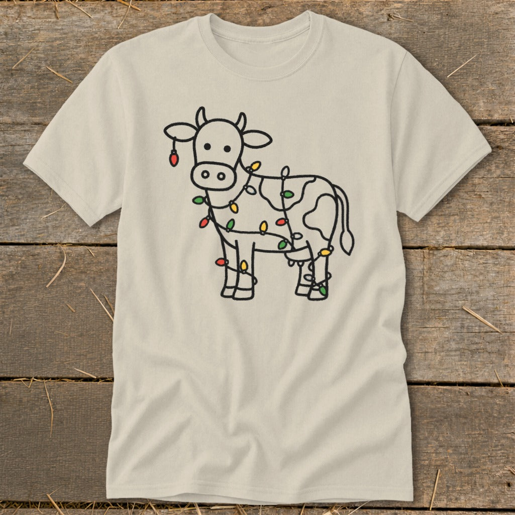 T-shirt with a cow outline decorated with colorful Christmas lights.