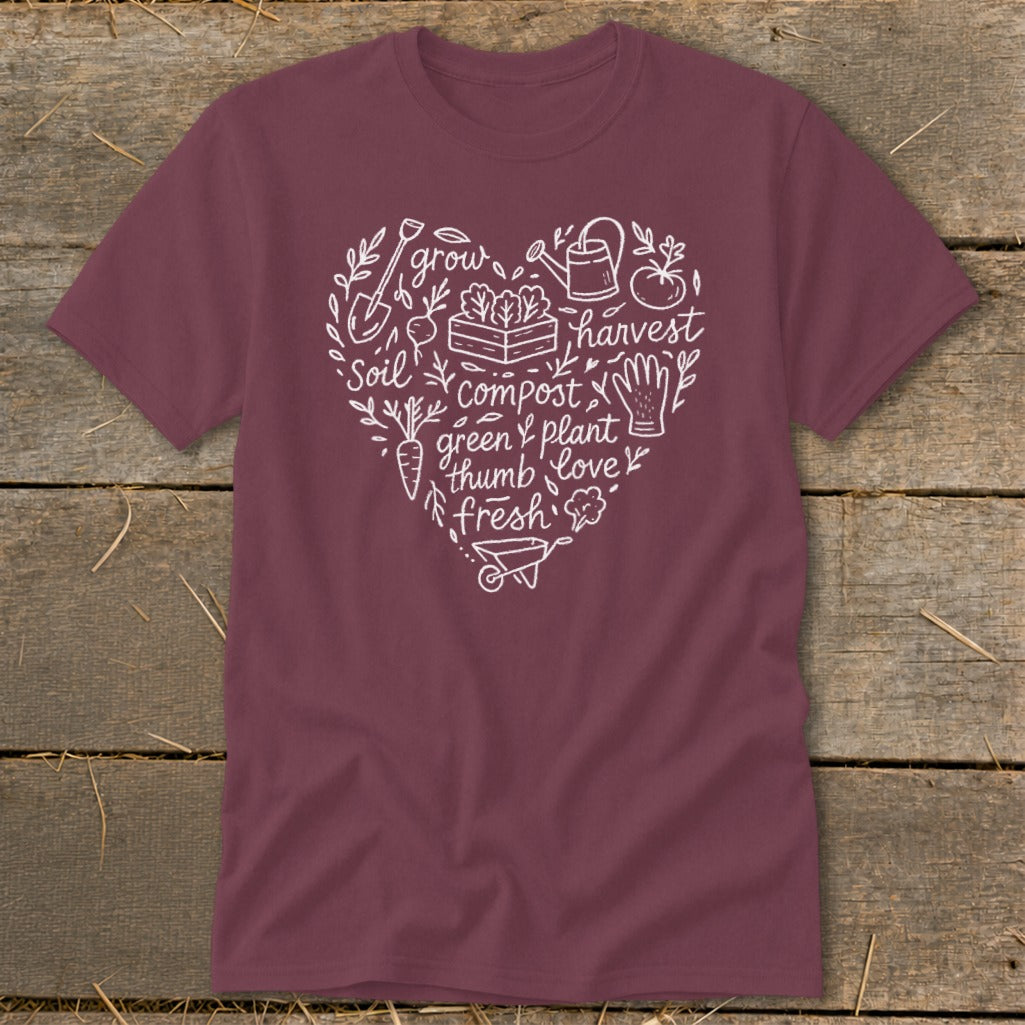 Maroon t-shirt with white heart-shaped garden graphic featuring soil, grow, harvest, compost, and love.