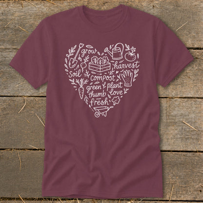 Maroon t-shirt with white heart-shaped garden graphic featuring soil, grow, harvest, compost, and love.