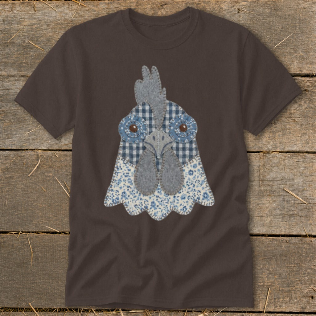 Brown t-shirt with a fabric applique of a chicken's face in blue and white patterns.