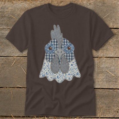 Brown t-shirt with a fabric applique of a chicken's face in blue and white patterns.