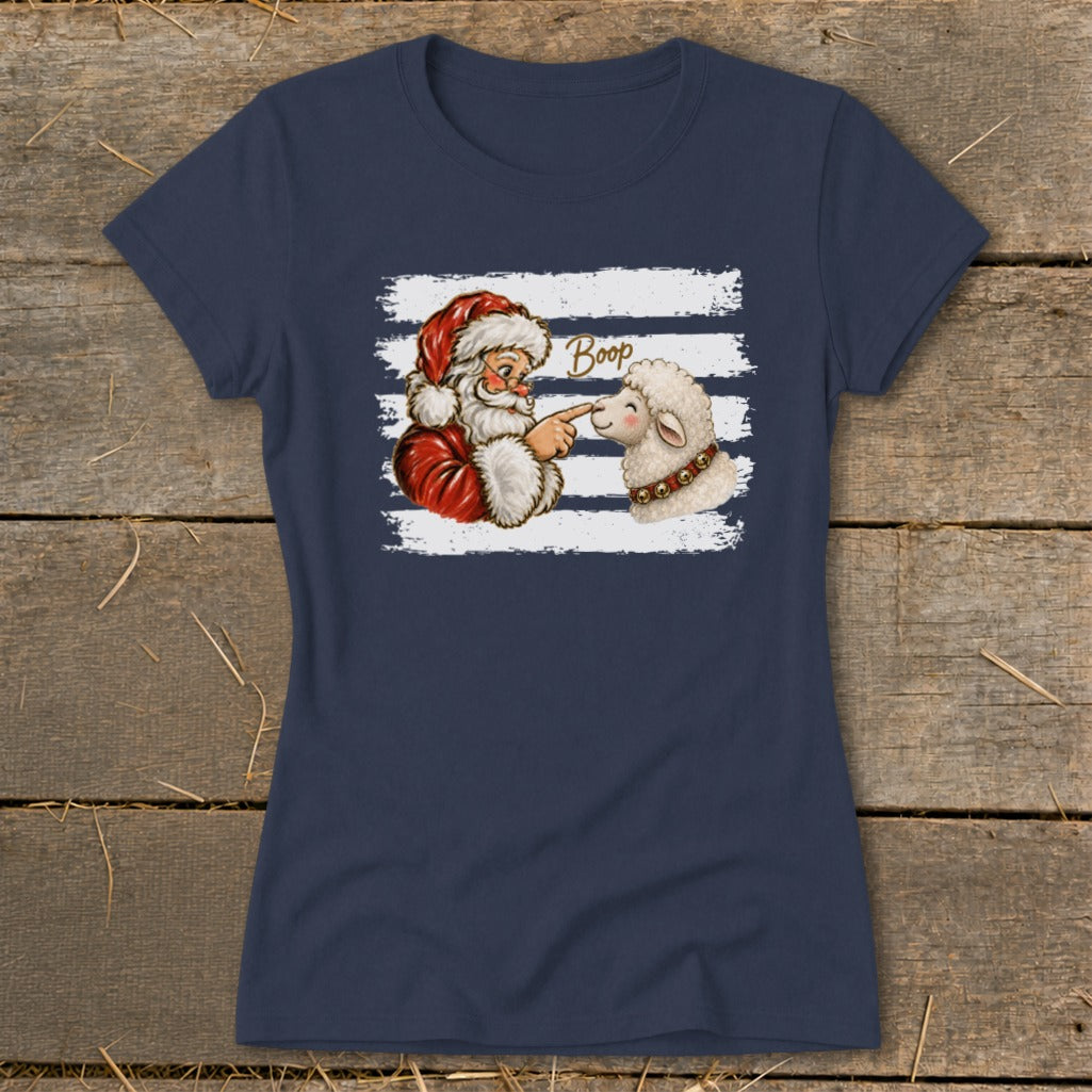 Santa Claus booping a sheep on the nose with the word "Boop".