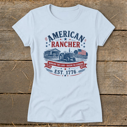 Light blue t-shirt with "American Rancher" graphic featuring a tractor, barn, and flag.
