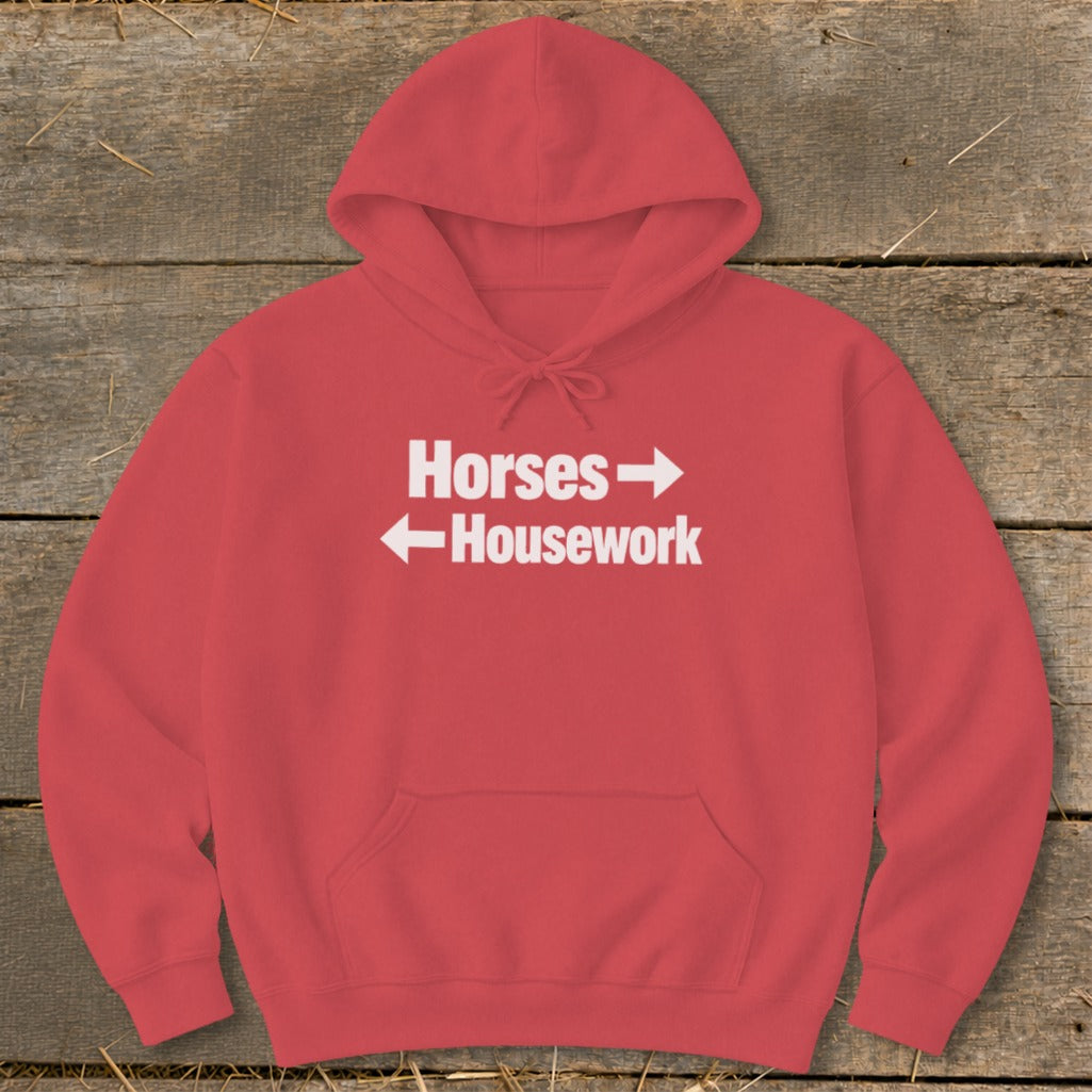 A red hooded sweatshirt with white text reading "Horses" above a right arrow and "Housework" below a left arrow.