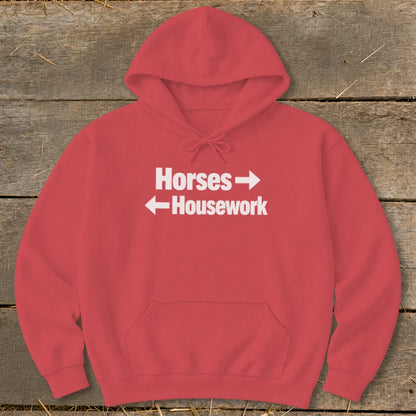 A red hooded sweatshirt with white text reading "Horses" above a right arrow and "Housework" below a left arrow.