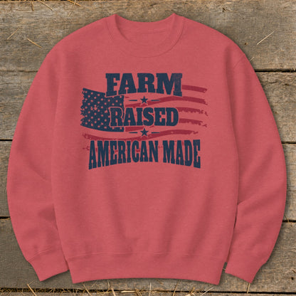 Crewneck sweatshirt with faded American flag graphic and text "FARM RAISED AMERICAN MADE".