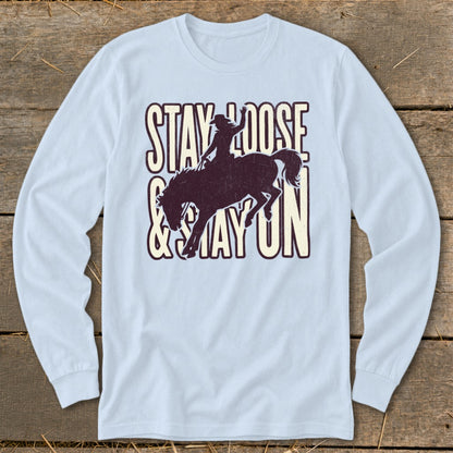 Light blue long-sleeve shirt with "STAY LOOSE & STAY ON" and bucking bronco graphic.