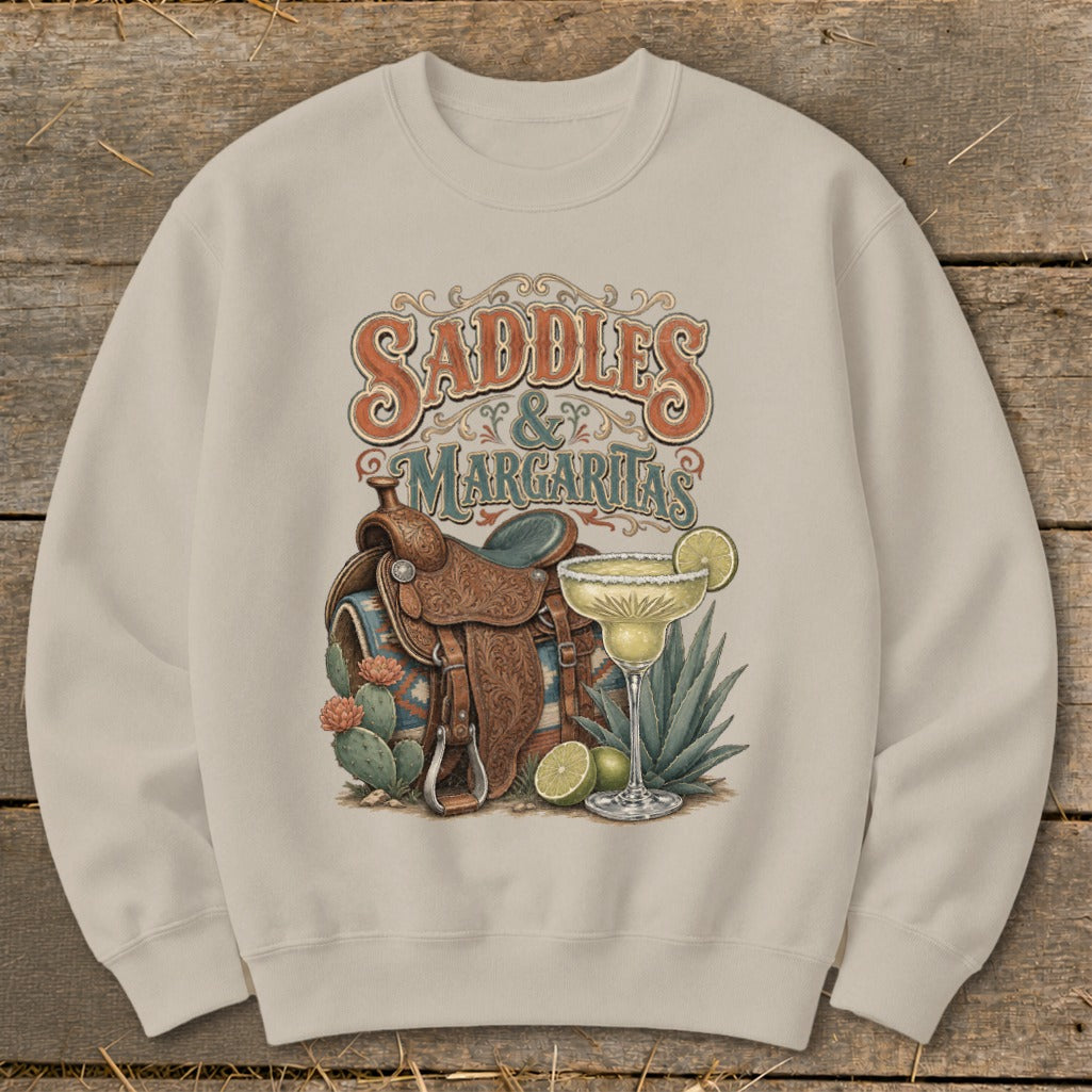 Crewneck sweatshirt with "Saddles & Margaritas" graphic featuring a saddle, margarita, and cacti.