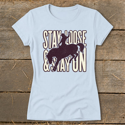 Light blue t-shirt with distressed "Stay Loose & Stay On" text and a bucking bronco.