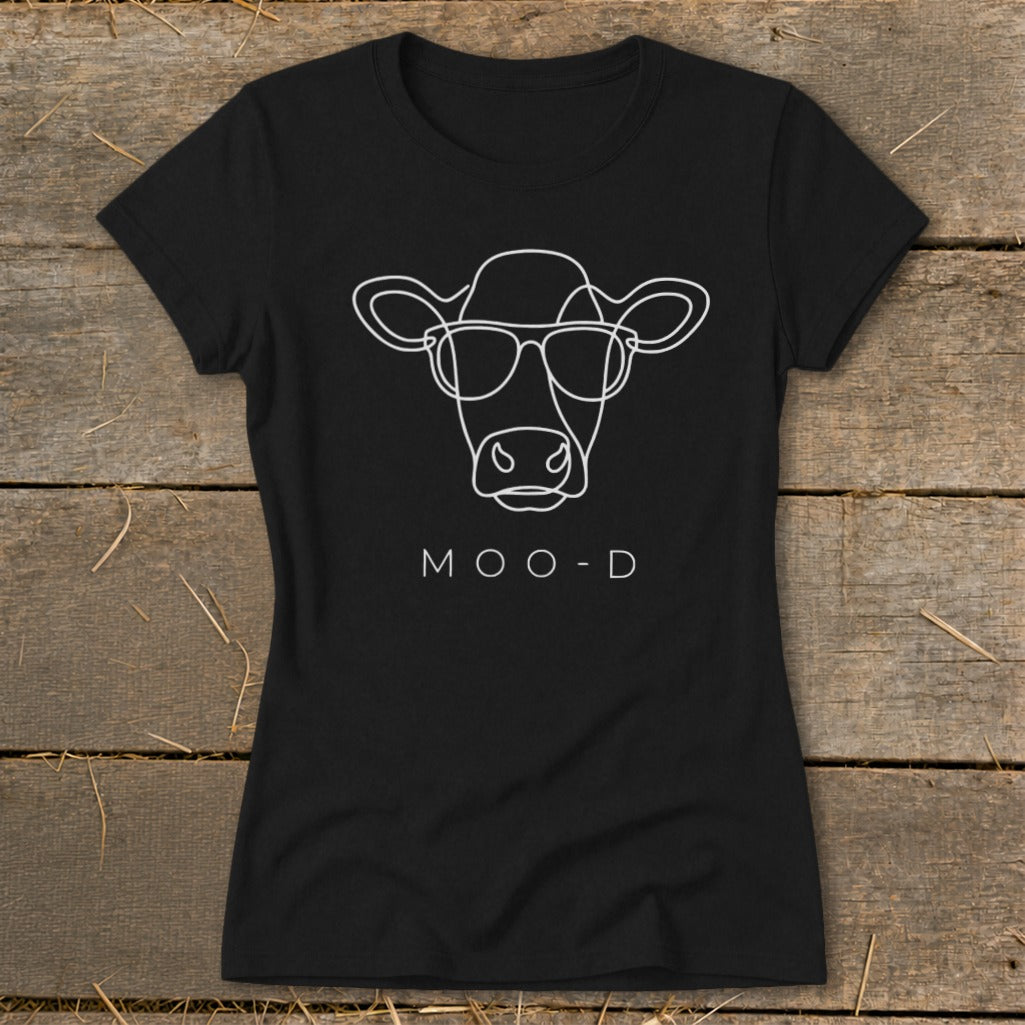 Black t-shirt with white line art of a cow wearing glasses and the text "MOO-D".