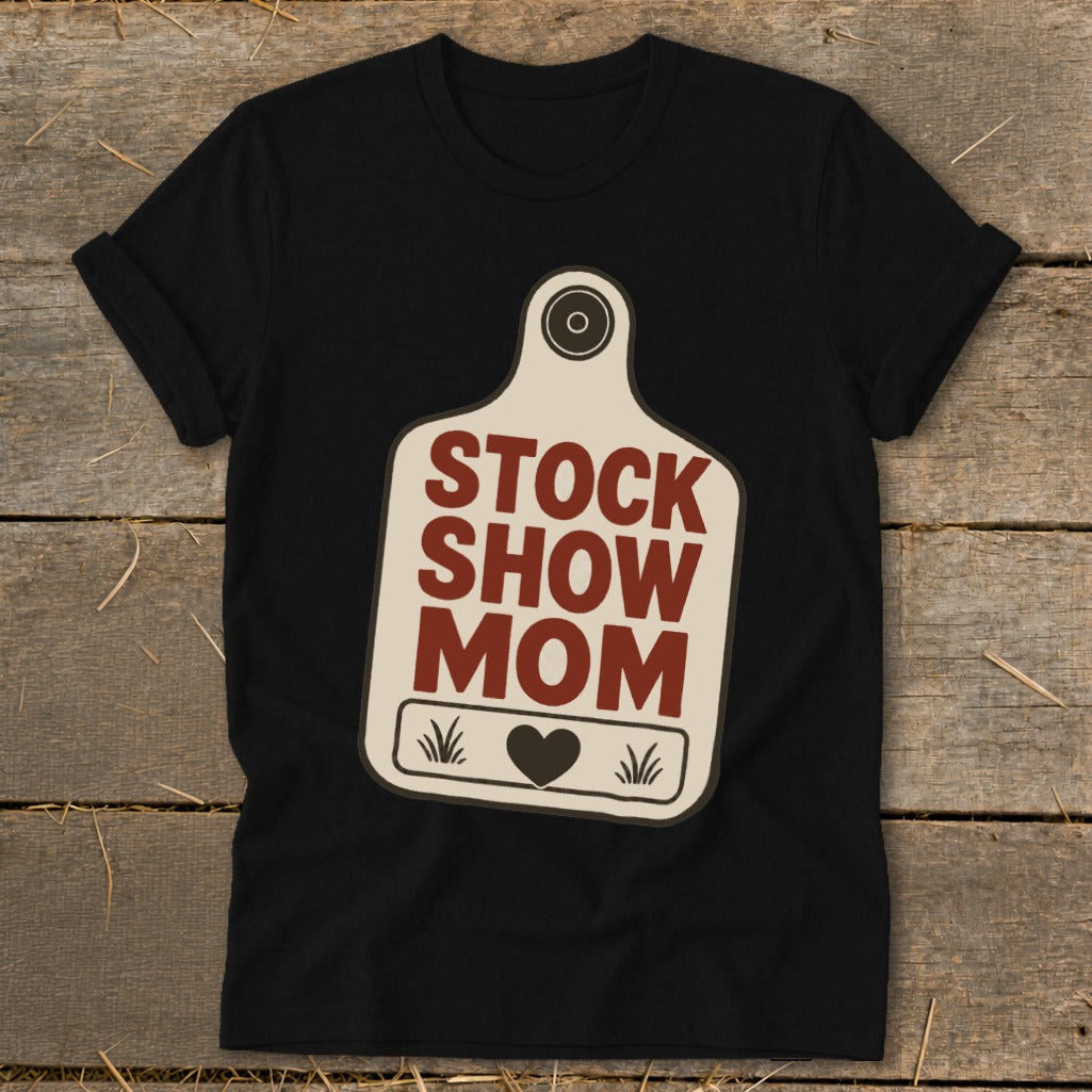 Black t-shirt with "Stock Show Mom" text on a tag design.