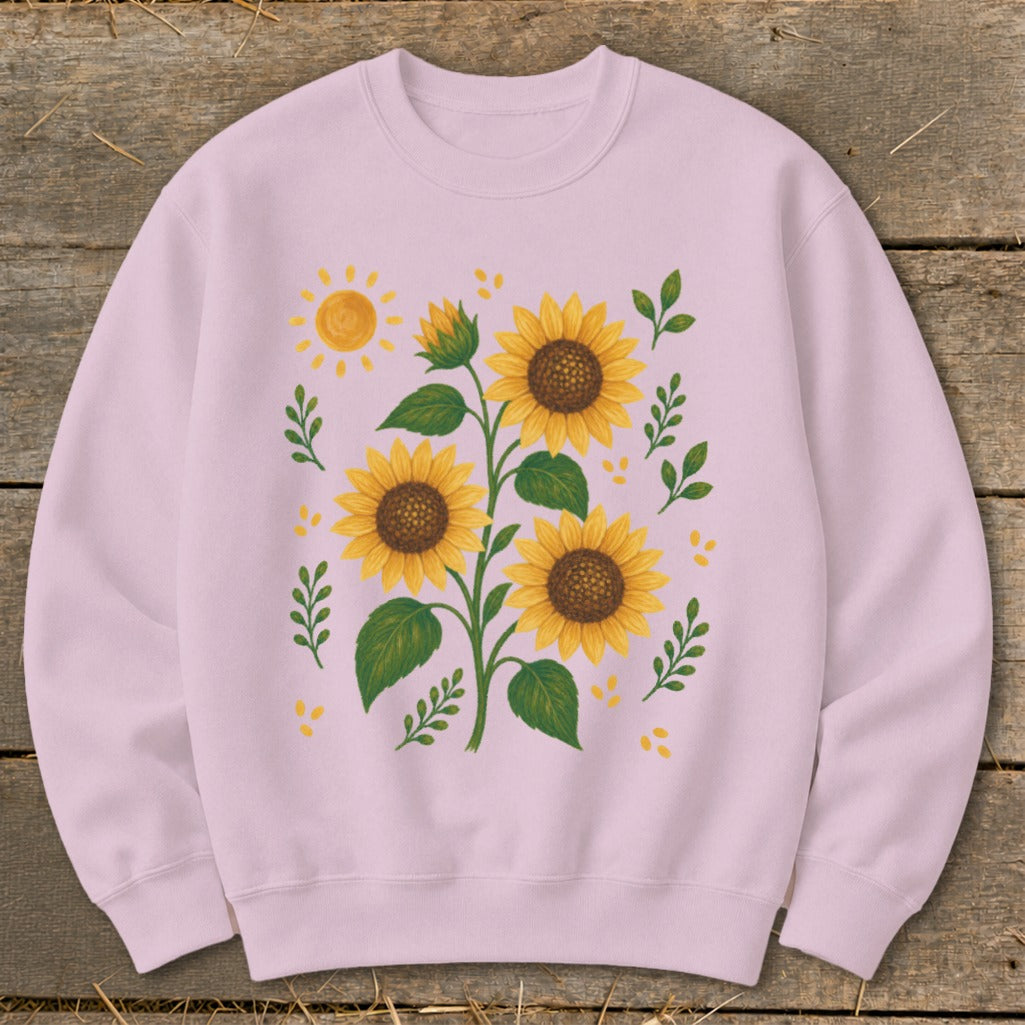 Pink sweatshirt with a watercolor-style print of sunflowers and a yellow sun.