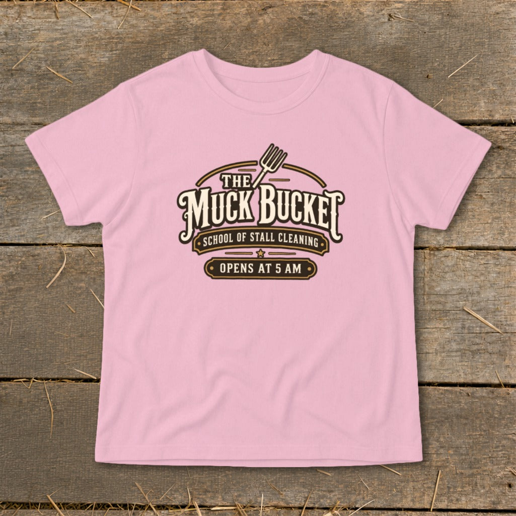 Pink t-shirt with "The Muck Bucket School of Stall Cleaning" graphic.