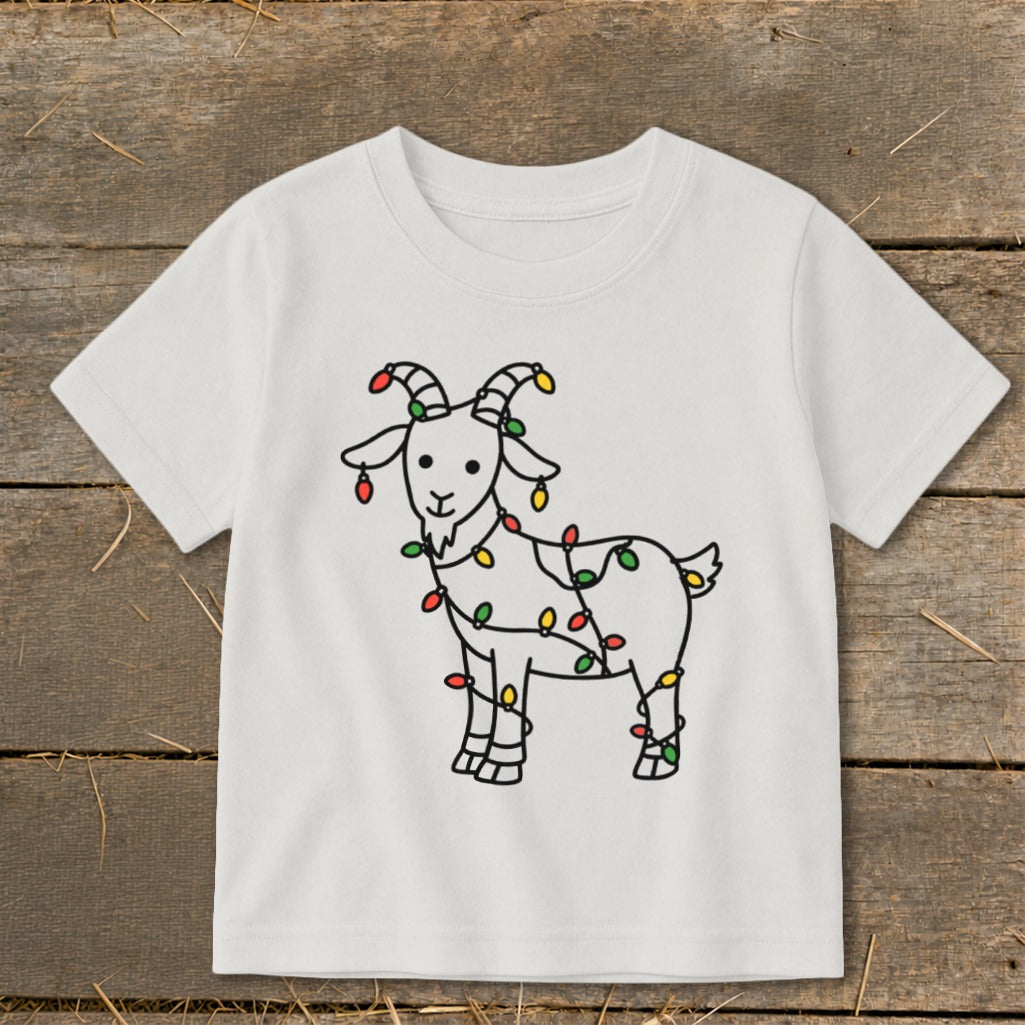 White t-shirt with a cartoon goat wrapped in colorful Christmas lights.