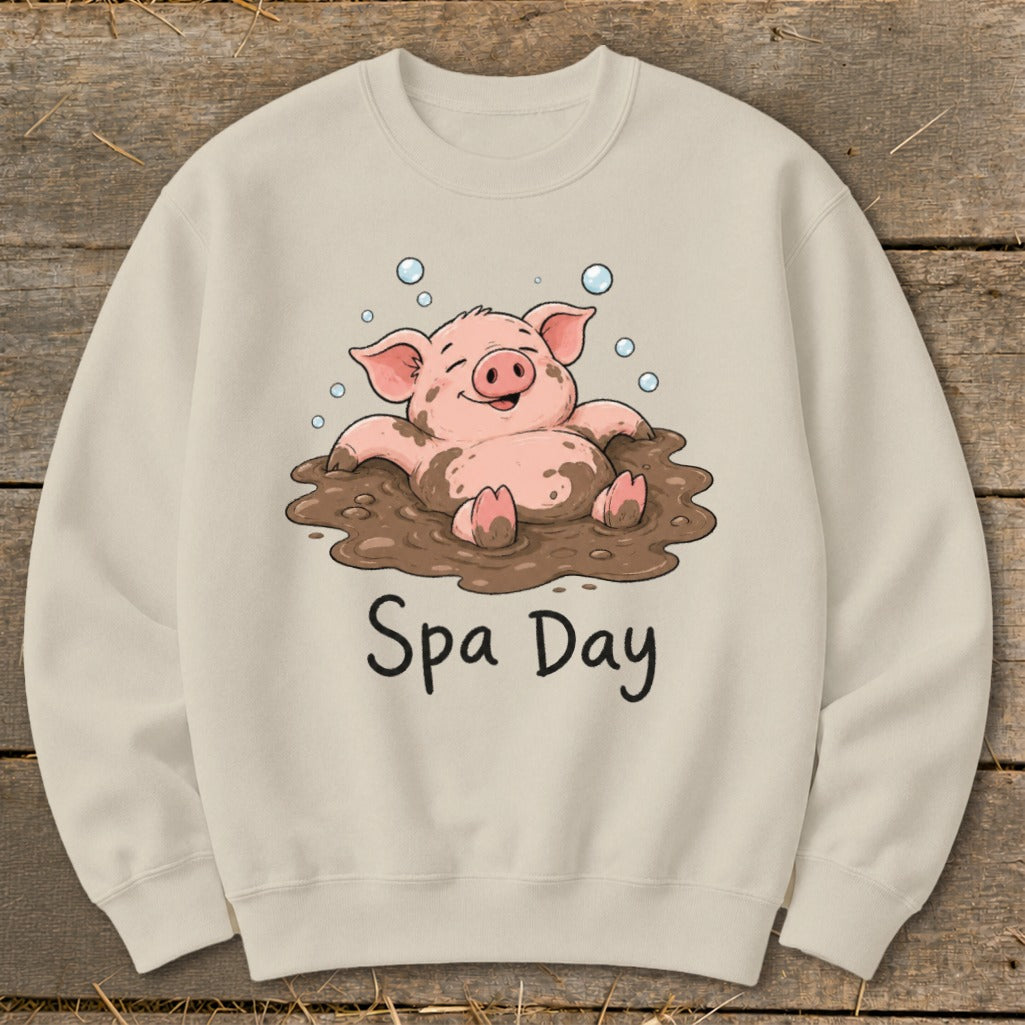 Cream sweatshirt with cartoon pig in mud and "Spa Day" text.
