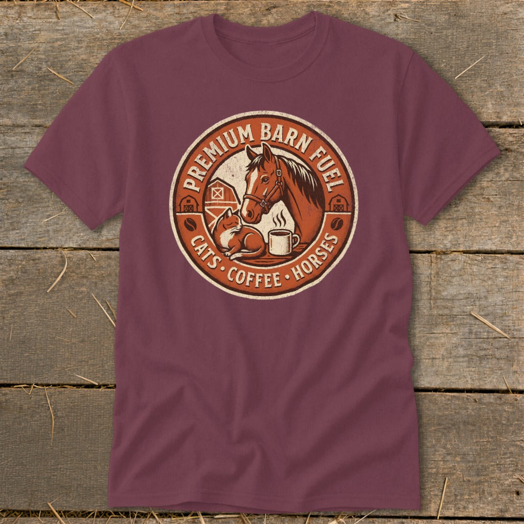 Burgundy t-shirt with circular graphic featuring a horse, cat, and coffee cup. Text reads "Premium Barn Fuel Cats Coffee Horses."