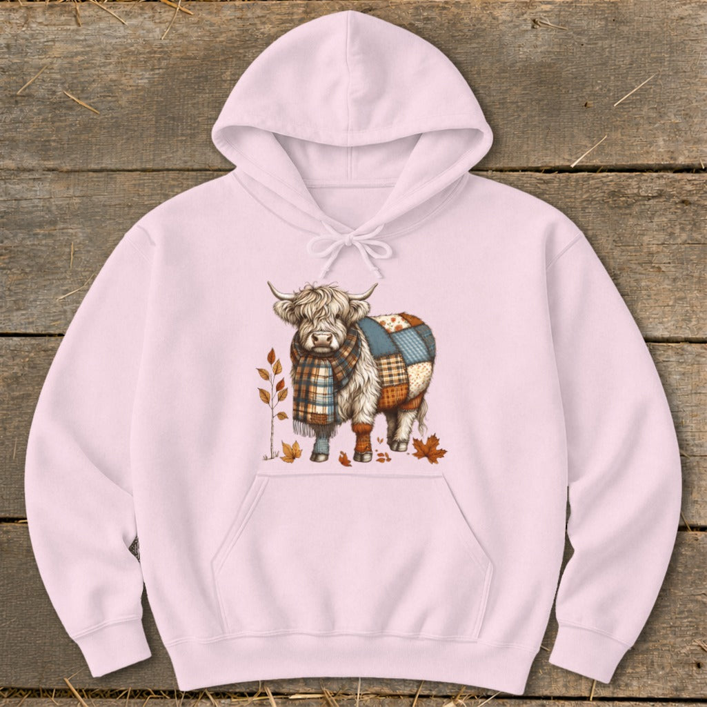 Pink hoodie with a Highland cow wearing a scarf and patchwork blanket.