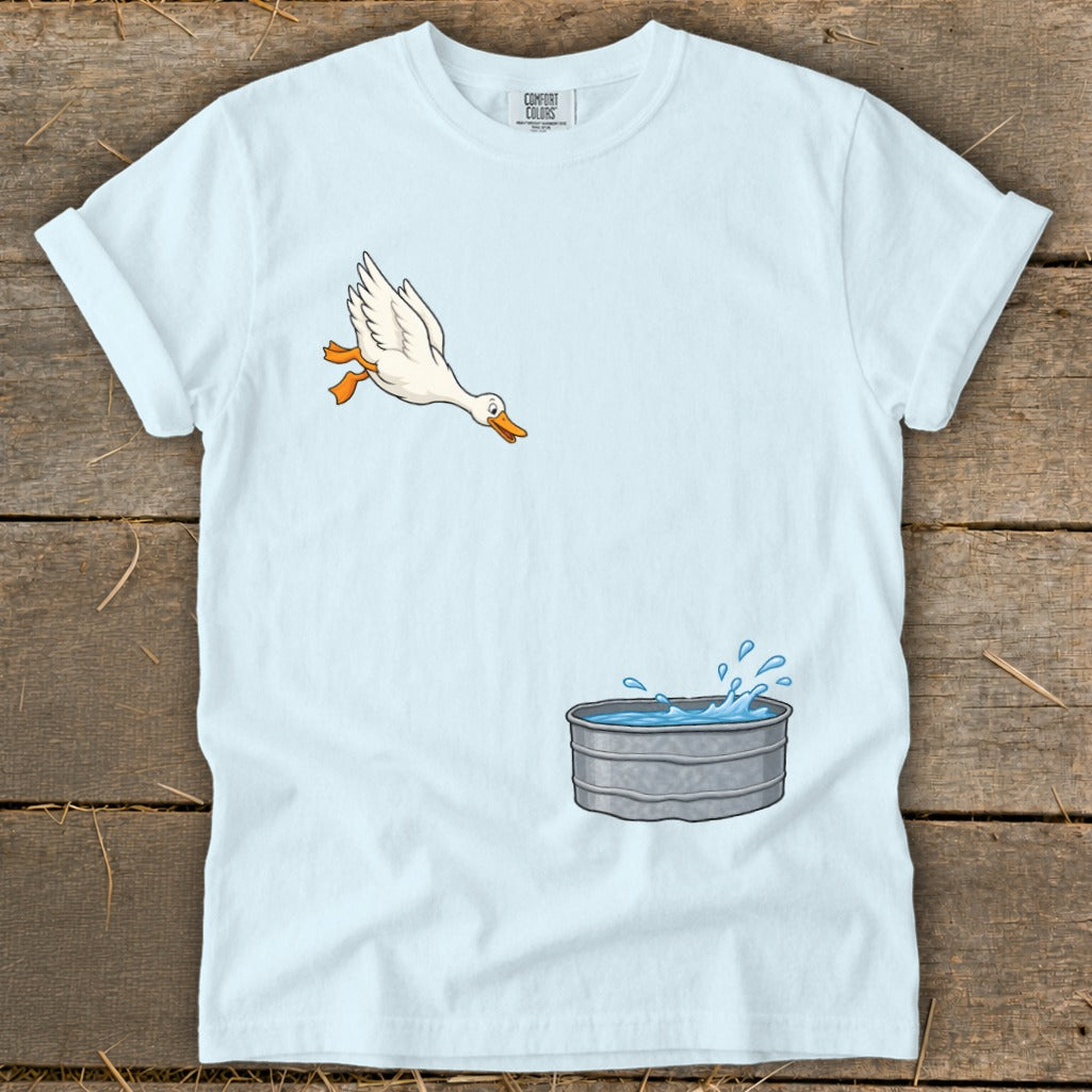 Light blue t-shirt with a cartoon duck jumping into a galvanized water tub.