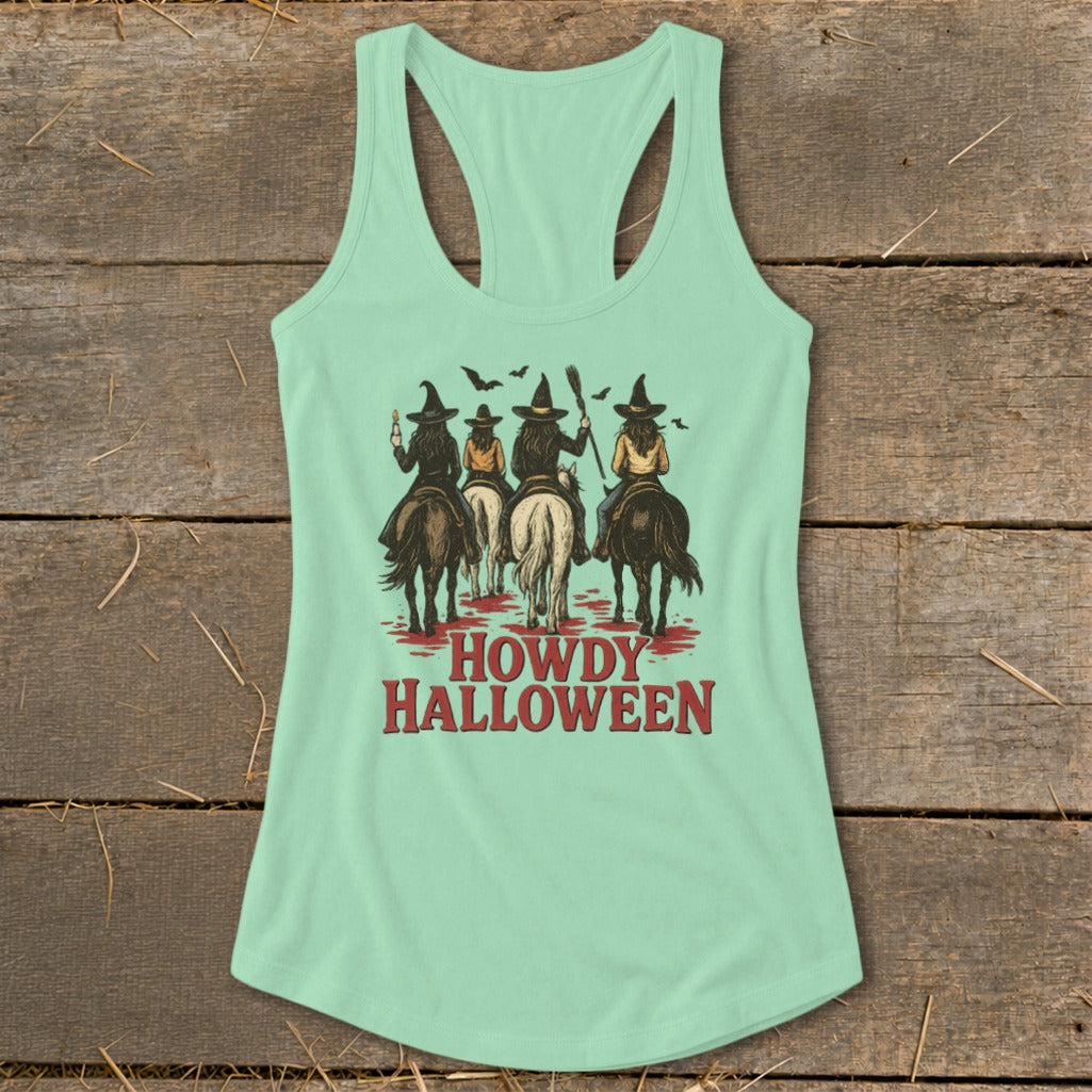 Mint green tank top with "Howdy Halloween" text and four witches on horseback.