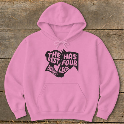 Pink hoodie with black text and horse head graphic: "The best therapist has four legs".