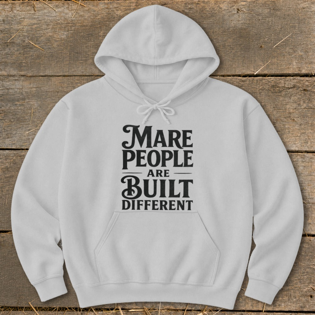 White hoodie with "Mare People Are Built Different" text graphic.