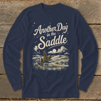 Navy long sleeve shirt with "Another Day in the Saddle" text and cowboy on horse graphic.
