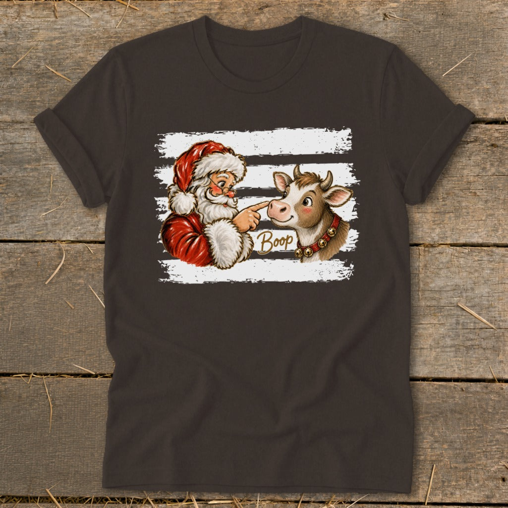 Santa booping a cow's nose with "Boop" text on a t-shirt.