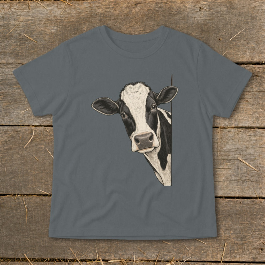 Black and white cow peeking around a corner on a gray t-shirt.