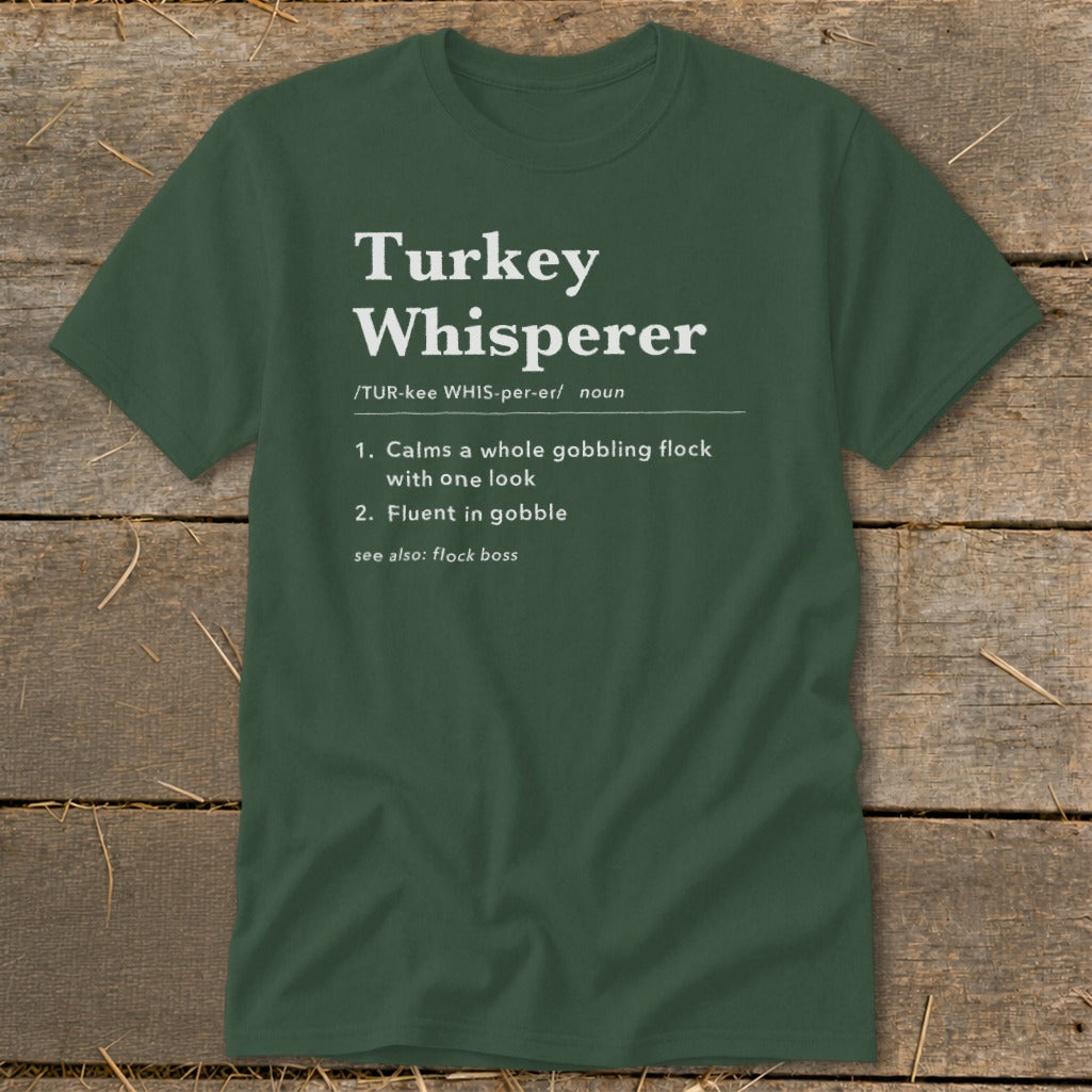 Green t-shirt with "Turkey Whisperer" definition: calms flock, fluent in gobble.