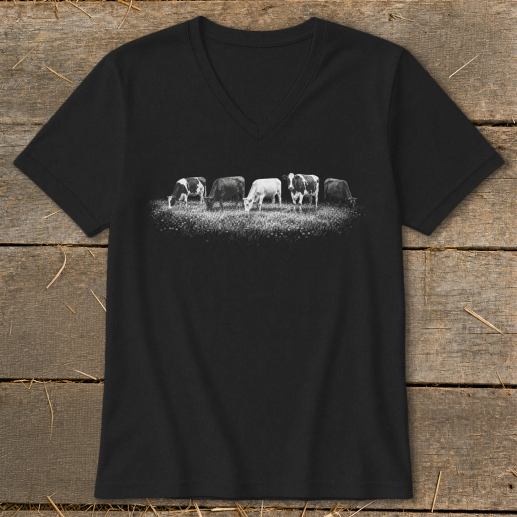 Black v-neck t-shirt with a line of five cows grazing in a field.