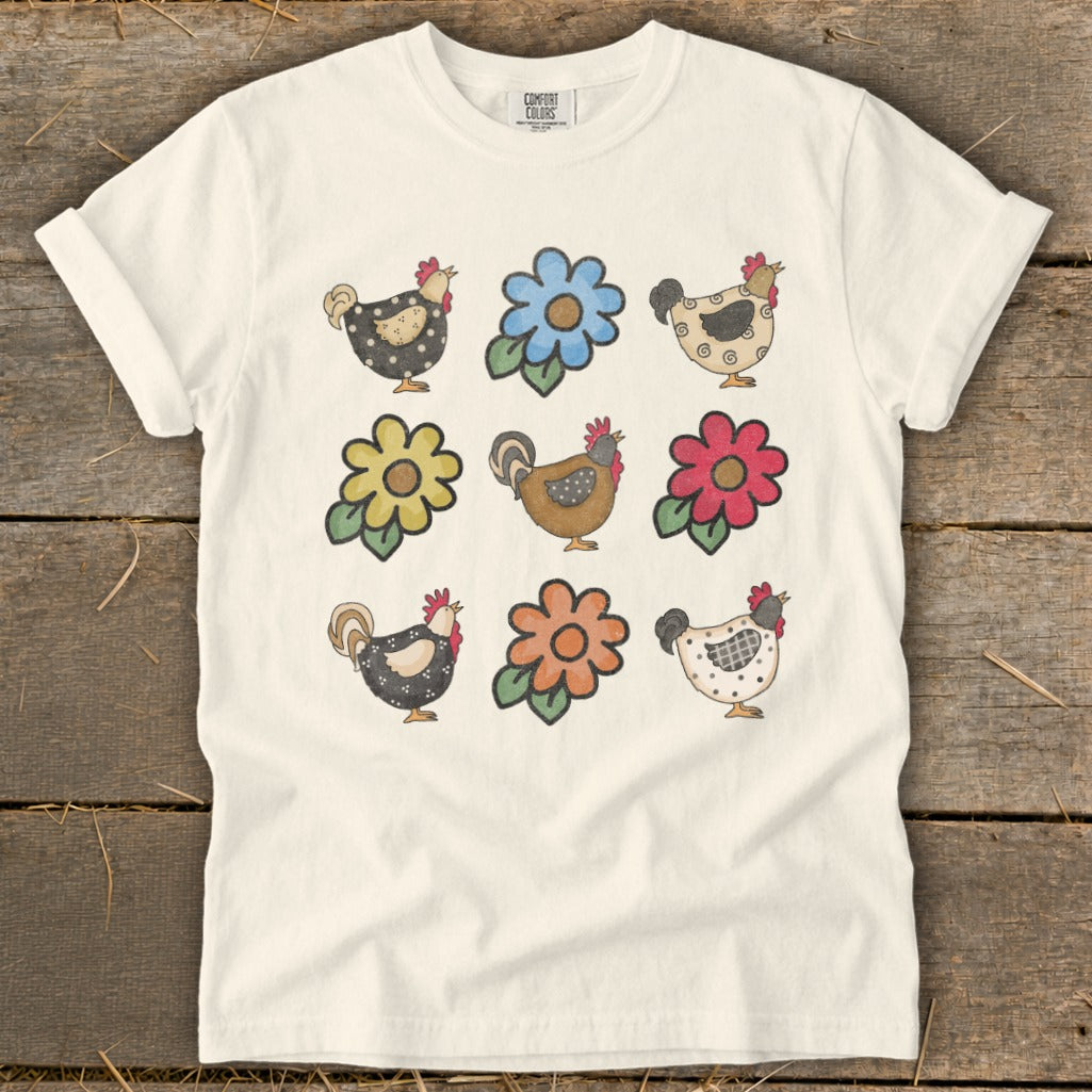 Cream t-shirt with repeated pattern of cartoon chickens and flowers.
