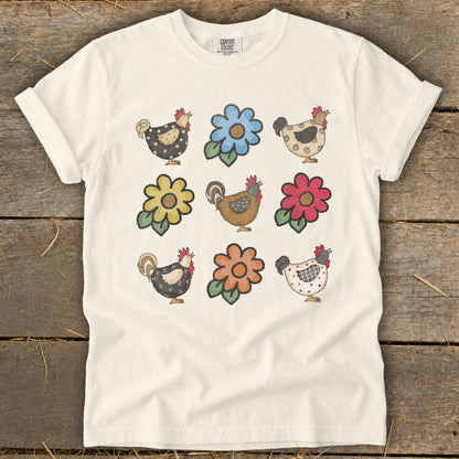 Cream t-shirt with repeated pattern of cartoon chickens and flowers.