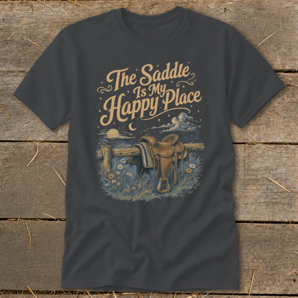 T-shirt graphic: "The Saddle Is My Happy Place" text above a saddle on a fence.