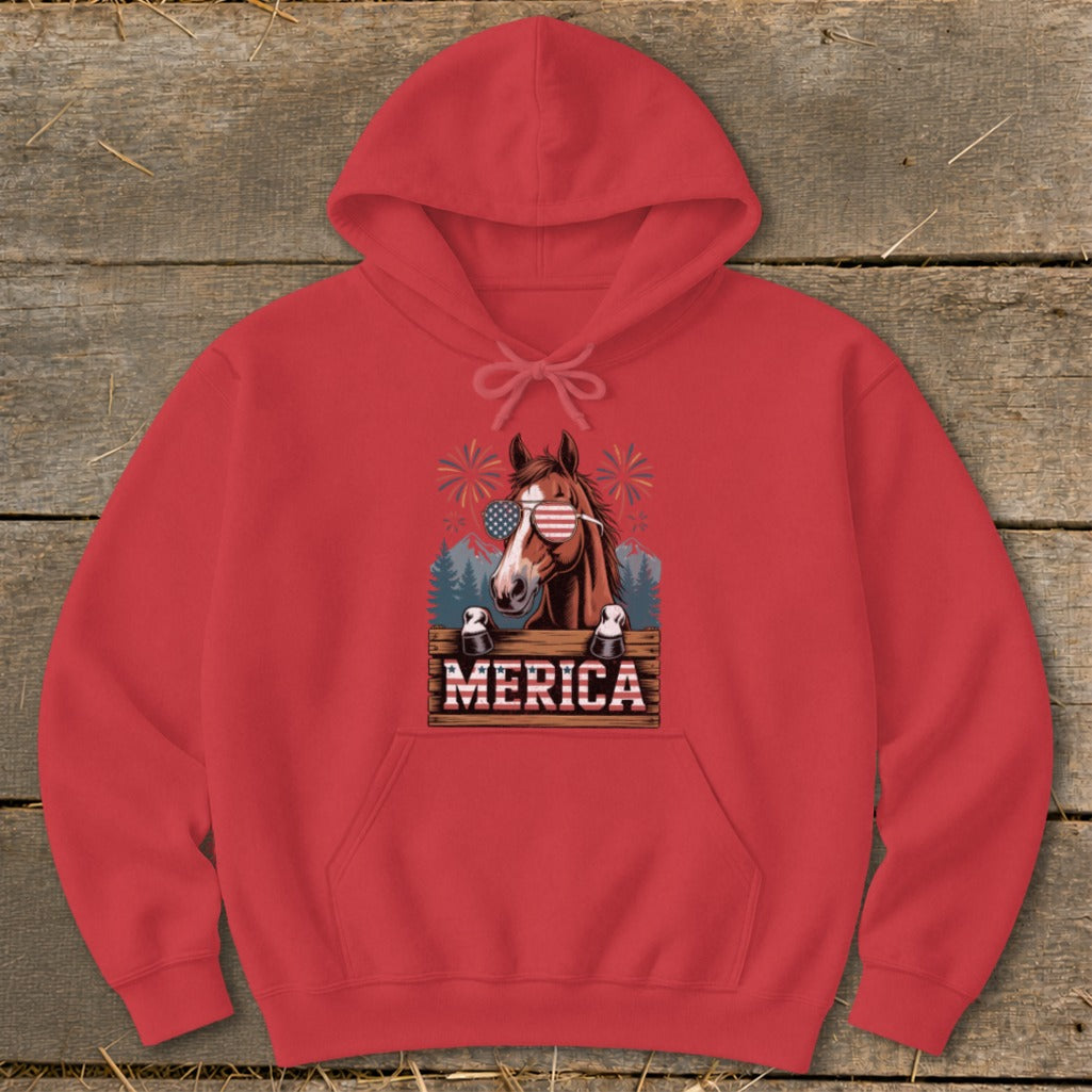 Horse wearing American flag sunglasses on a red hoodie with "MERICA" text.