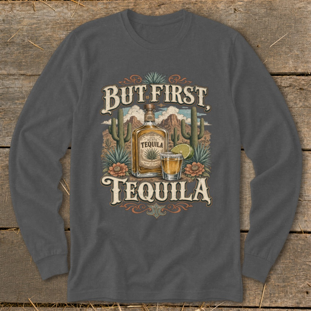 T-shirt graphic with "But First, Tequila" text, a tequila bottle, shot glass, and desert landscape.
