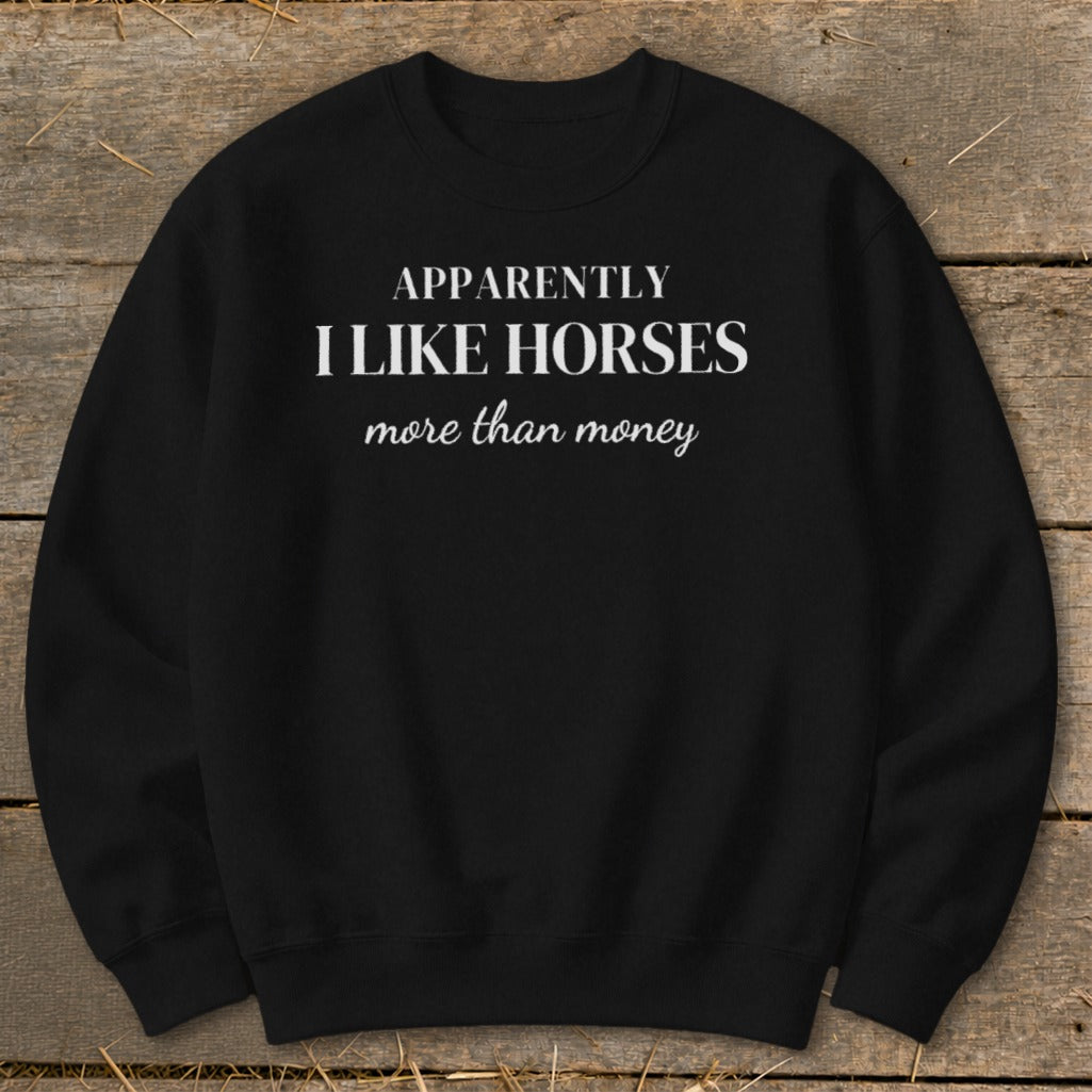 Black sweatshirt with white text: "APPARENTLY I LIKE HORSES more than money".