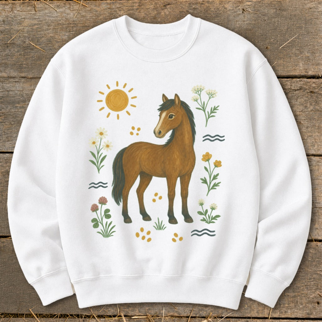 White sweatshirt with a brown horse illustration surrounded by flowers and sun.