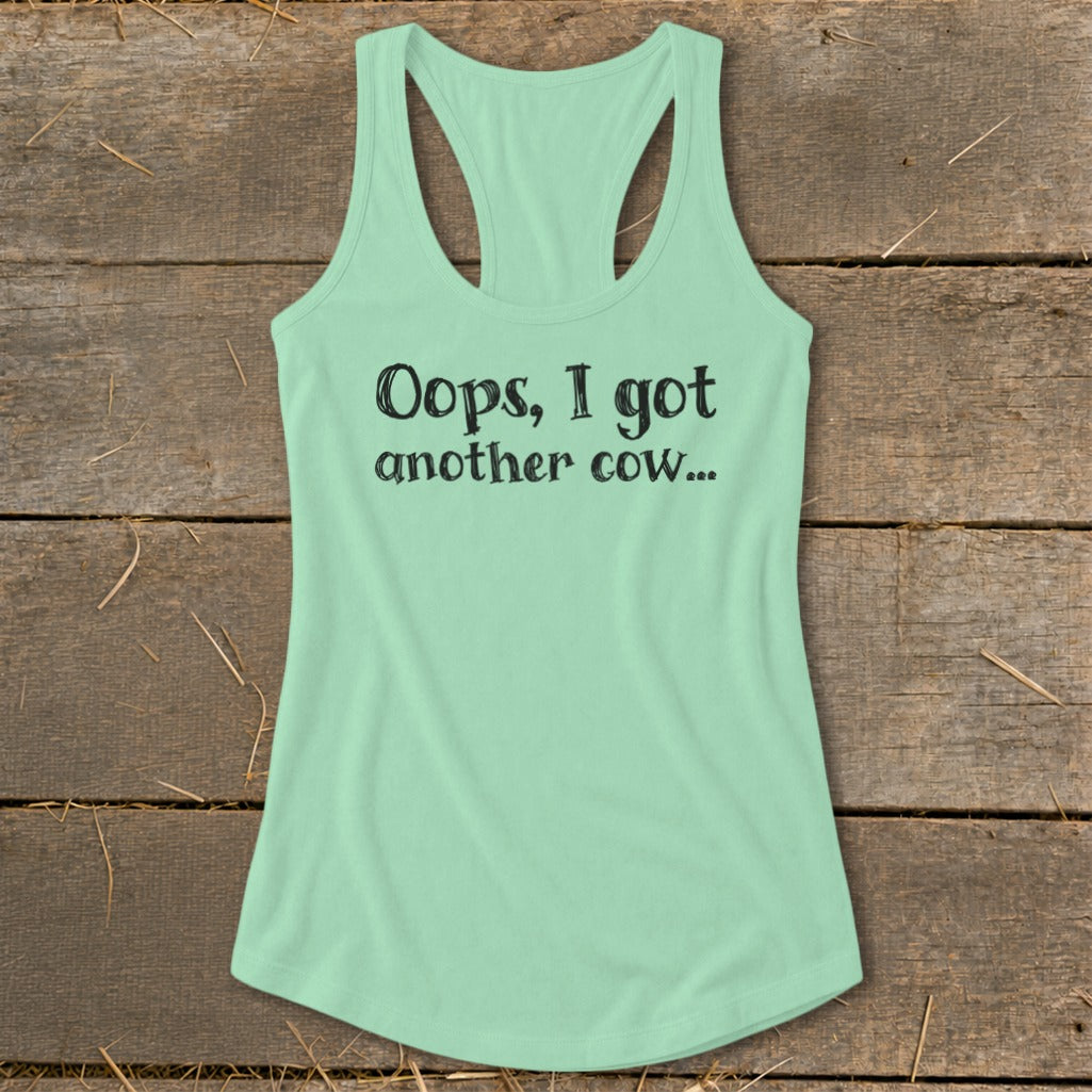 Mint green tank top with "Oops, I got another cow..." text.