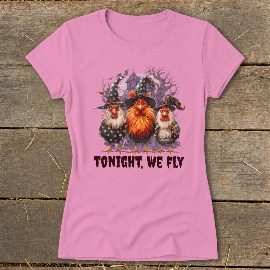 Three chickens wearing witch hats stand before a spooky house with the text "TONIGHT, WE FLY."