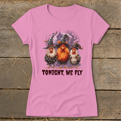 Three chickens wearing witch hats stand before a spooky house with the text "TONIGHT, WE FLY."