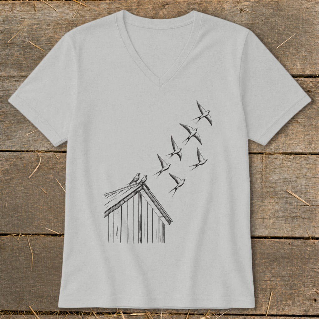 Light gray V-neck t-shirt featuring a black line drawing of birds flying from a shed roof.