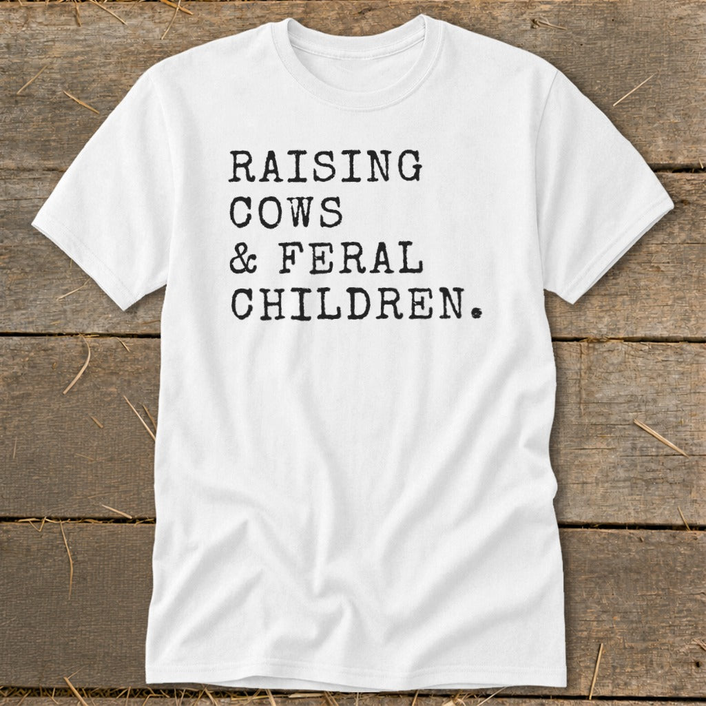White t-shirt with black text reading "RAISING COWS & FERAL CHILDREN."