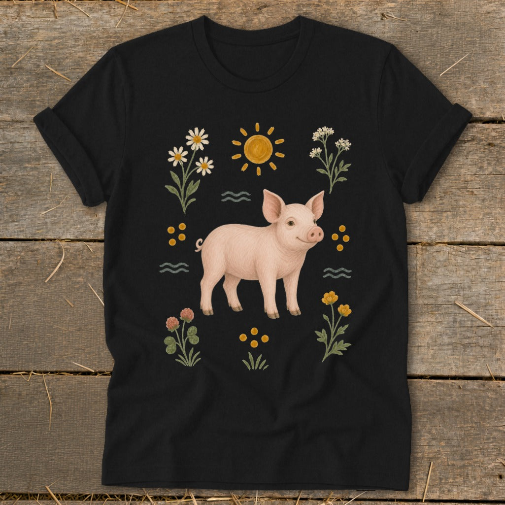 Black t-shirt with a pink pig surrounded by flowers, sun, and wavy lines.