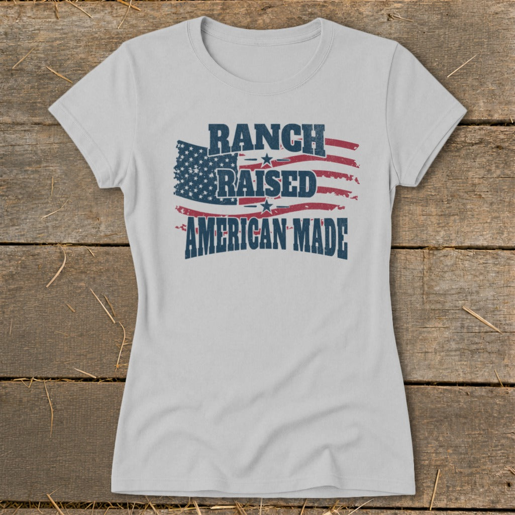Light grey t-shirt with American flag graphic and text "RANCH RAISED AMERICAN MADE".