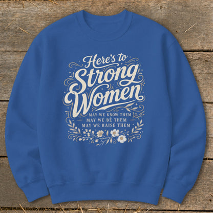 Royal blue sweatshirt with "Here's to Strong Women" text and floral design.