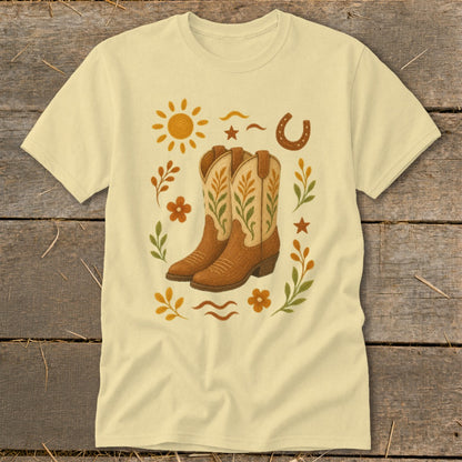 Light yellow t-shirt with cowboy boots, sun, horseshoe, and floral accents.