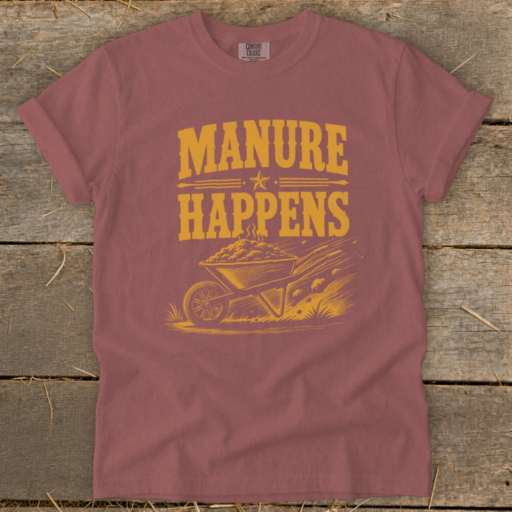 T-shirt with "MANURE HAPPENS" text and illustration of a wheelbarrow full of manure.