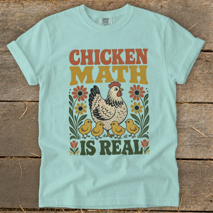 Light blue t-shirt with "Chicken Math is Real" text, chicken, and chicks graphic.