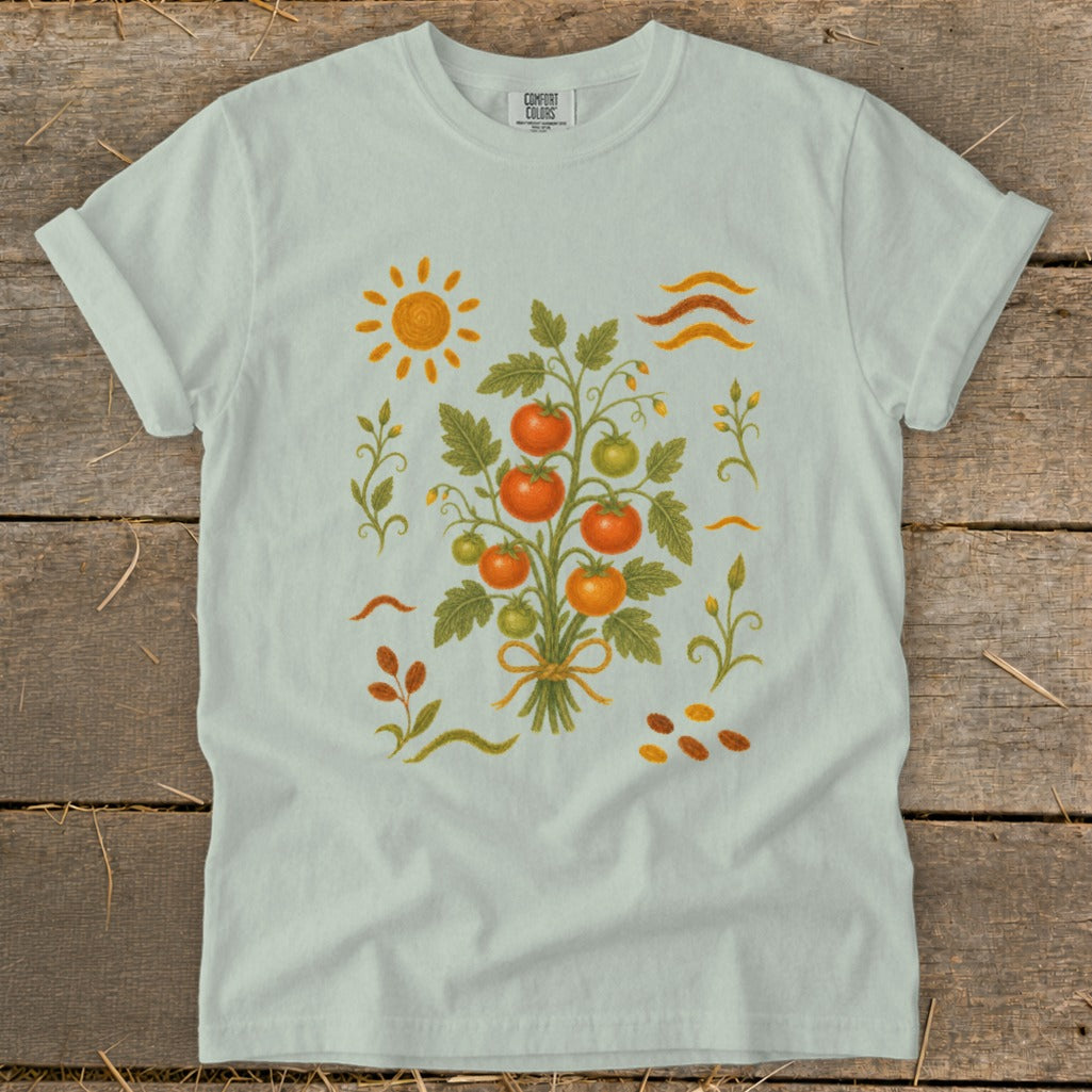Light blue t-shirt with a graphic of a tomato plant and sun.