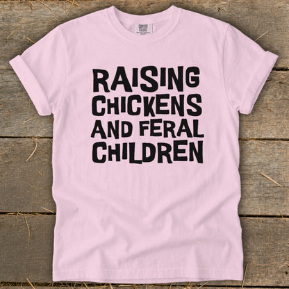 Pink t-shirt with black text that reads "Raising Chickens and Feral Children".
